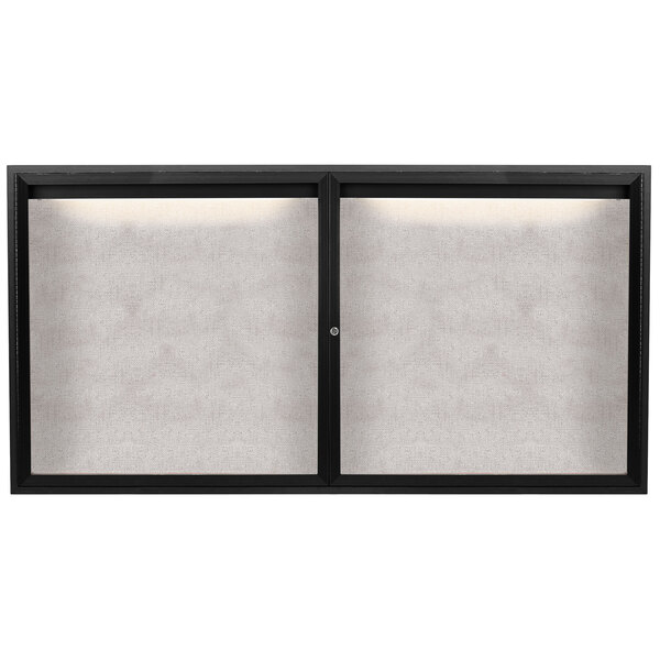 A black powder coated Aarco outdoor bulletin board cabinet with two doors and a white screen window.