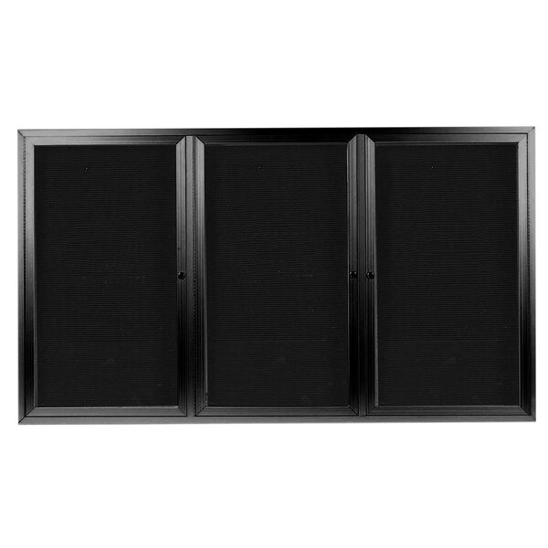 A black cabinet with three doors containing black letter boards.