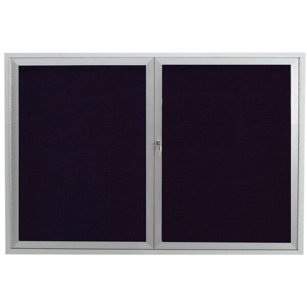 A black rectangular message center with silver framed doors containing black letter board.