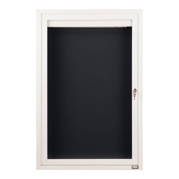 A white-framed, glass-fronted display case with a black interior and a lock on the right side.