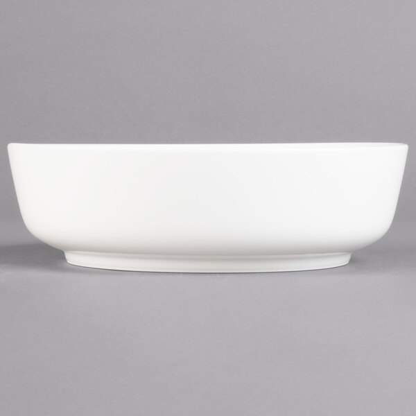 A Villeroy & Boch white porcelain salad bowl on a gray background.