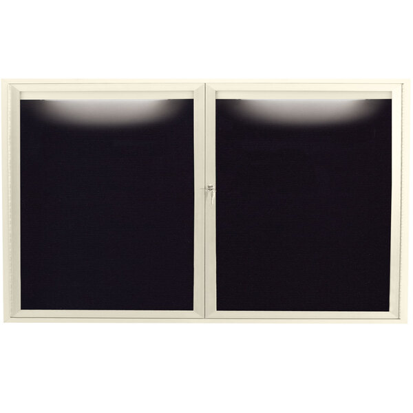 An ivory Aarco indoor message center with two black panels and a white window with black letter board.