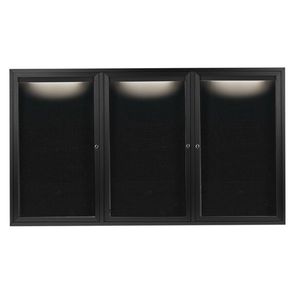 A black rectangular Aarco message center with three glass doors and a black letter board inside.