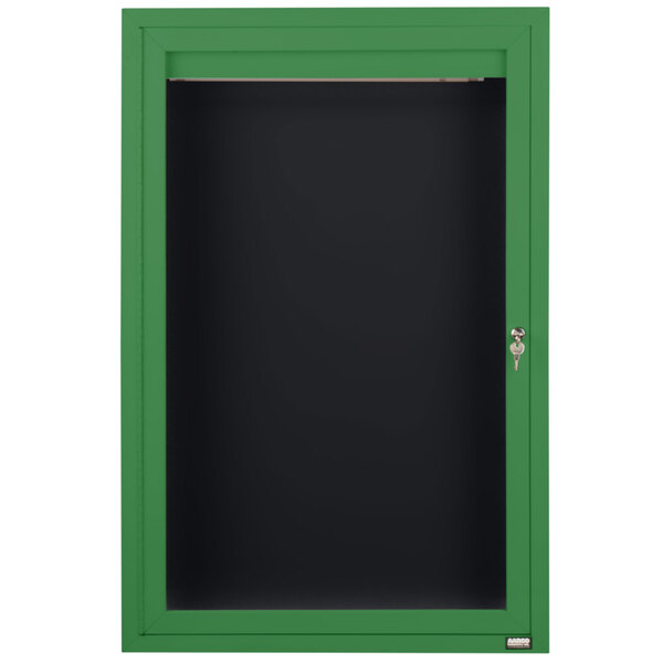A green cabinet with a black door and board.