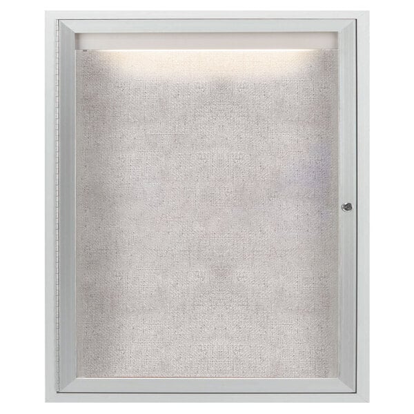 A white enclosed Aarco bulletin board cabinet with a lighted window.
