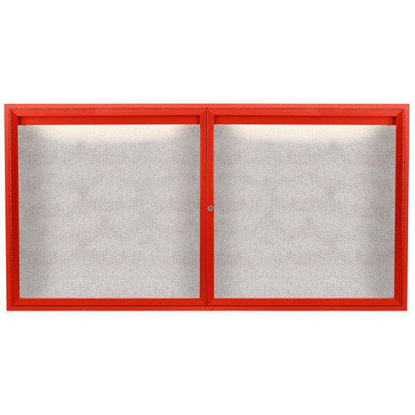 A white board with a red frame and two red glass doors with white screens.