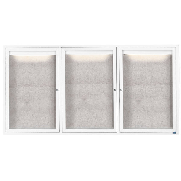 A white Aarco outdoor bulletin board cabinet with three glass doors.