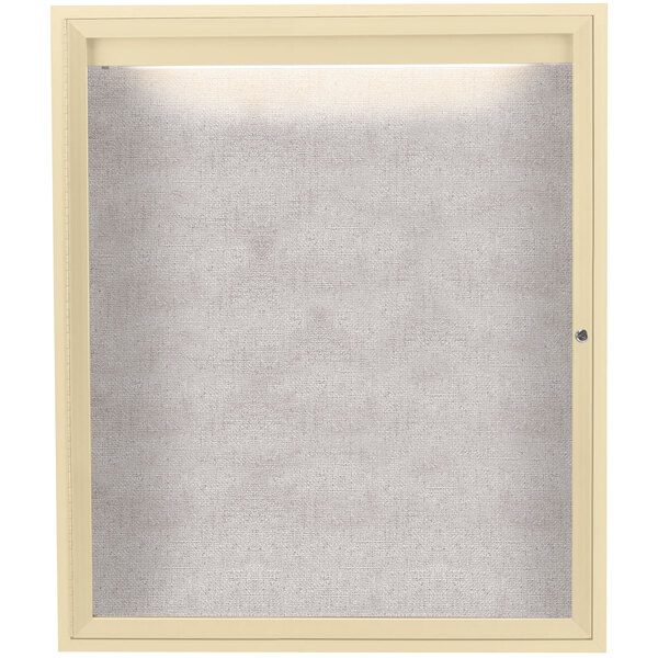 An ivory enclosed bulletin board with a lighted window.