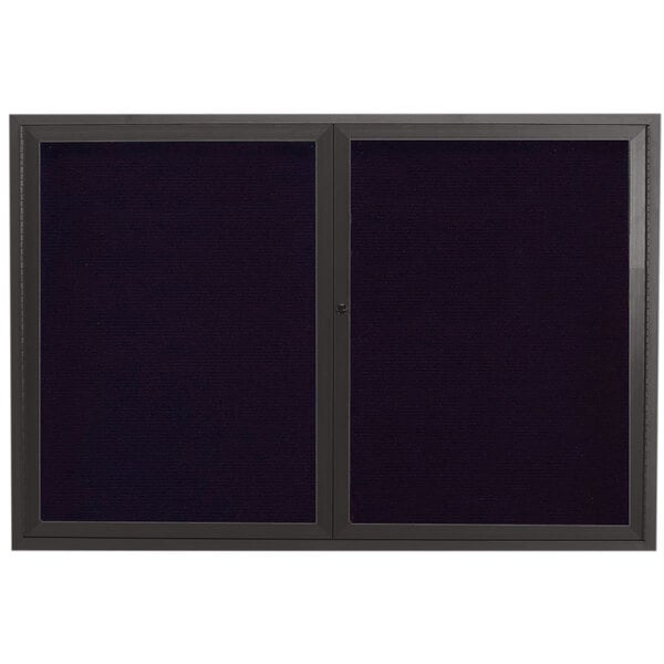 A black rectangular Aarco message center with a black metal frame and two black doors.