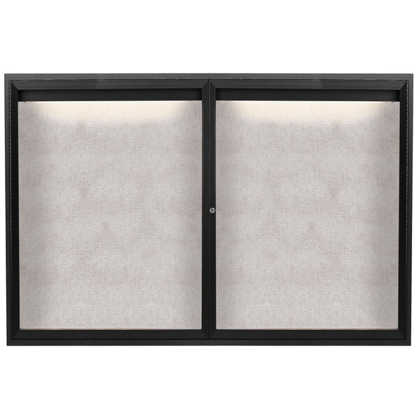 A black framed door with white screen on a black and white bulletin board.