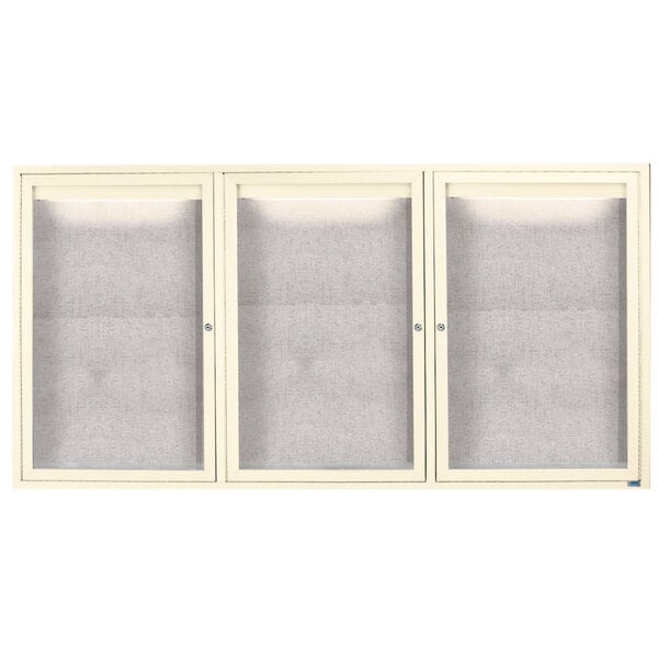 A white Aarco cabinet with three glass doors.