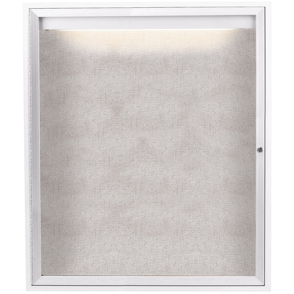 A white enclosed bulletin board cabinet with a lighted window.