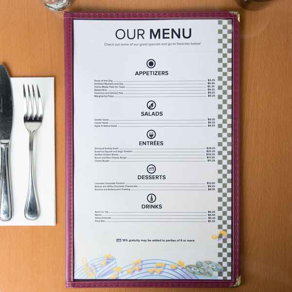 Menu paper with a retro jukebox design on a table with a fork and knife.