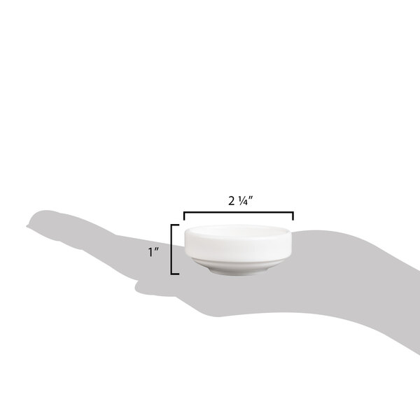A hand holding a small white porcelain bowl.