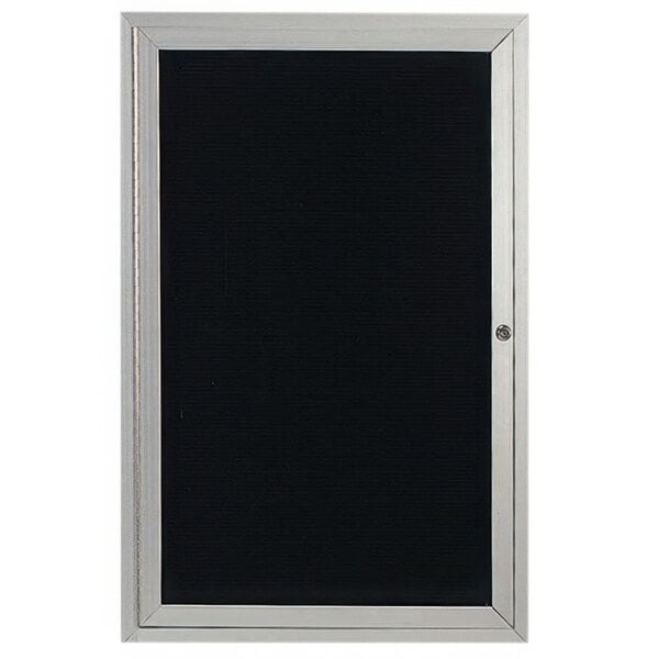 A black board with a silver frame inside a black enclosed door.