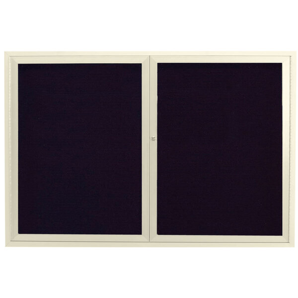 An ivory rectangular message center with two black framed doors with white letter board.