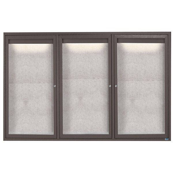 A row of glass doors with a black frame enclosing a white rectangular bulletin board.