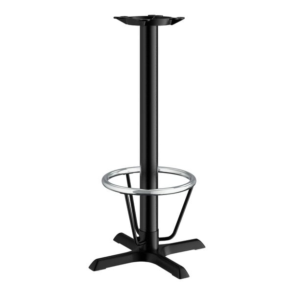 A Lancaster Table & Seating black cast iron bar height table base with a foot ring.