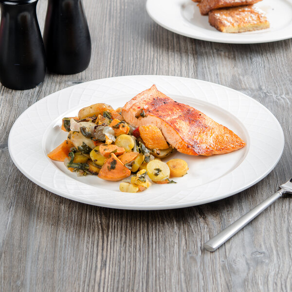 A piece of cooked salmon on a white Villeroy & Boch porcelain plate with a silver knife.