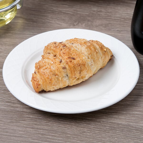 A croissant on a Villeroy & Boch white porcelain plate.