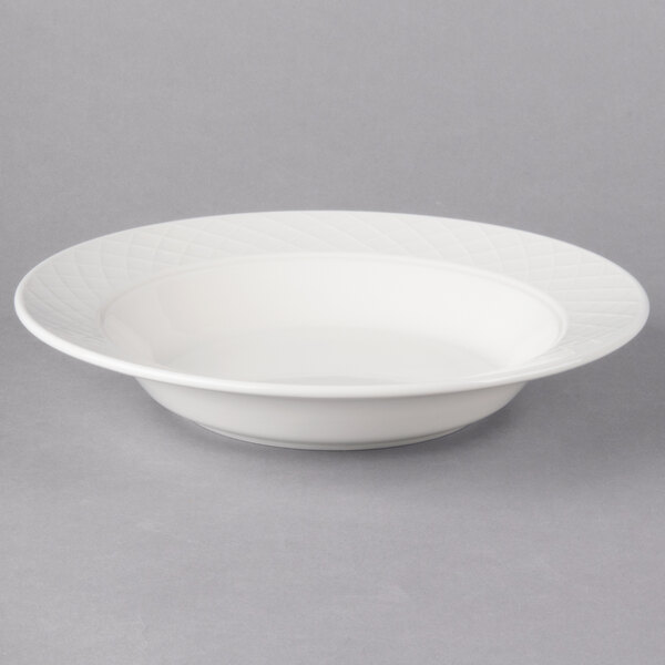 A Villeroy & Boch white porcelain deep plate with a curved edge on a gray background.
