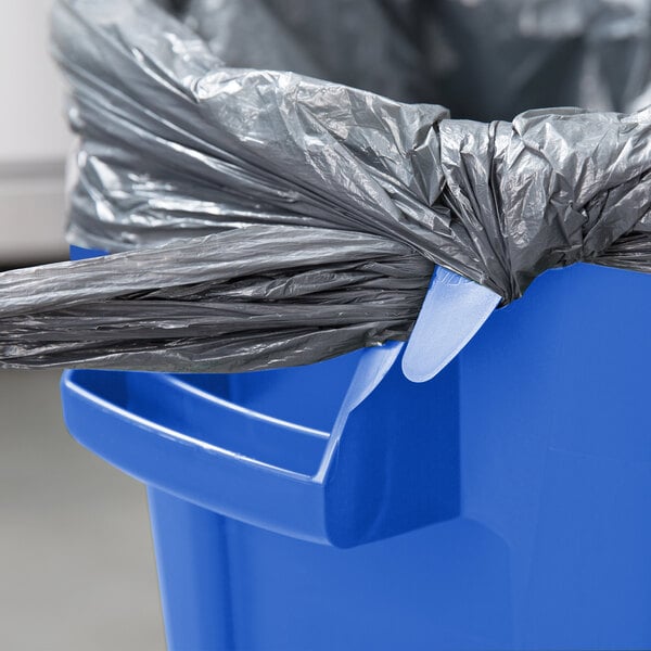 A blue Rubbermaid BRUTE recycling can with a plastic lid and a black bag inside.