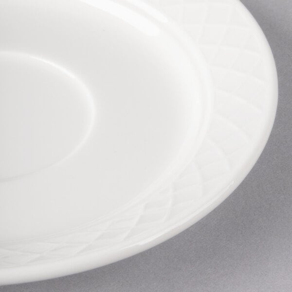 A white Villeroy & Boch porcelain saucer with a circular design.