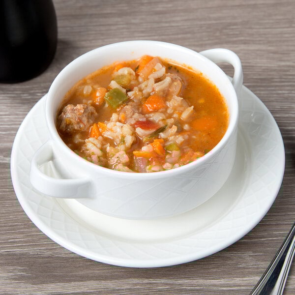 A white Villeroy & Boch porcelain saucer with a bowl of soup on it.