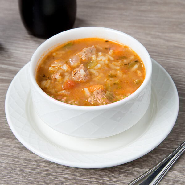 A bowl of soup on a white Villeroy & Boch porcelain saucer.