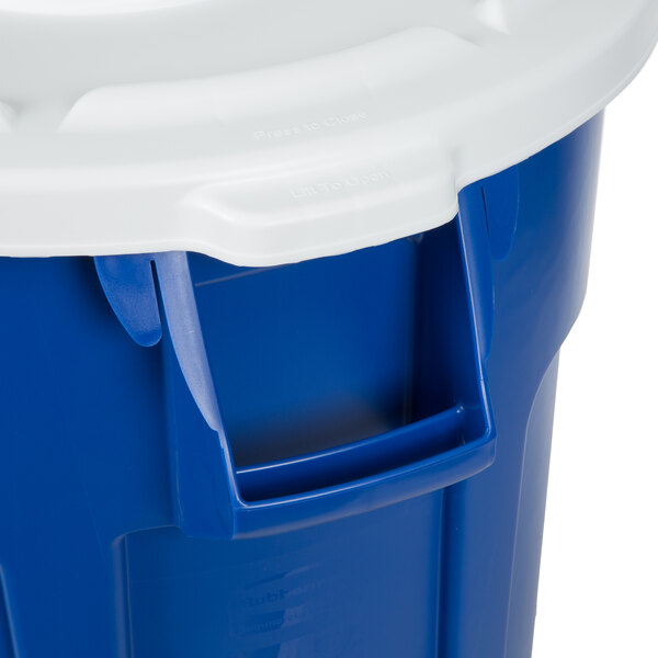 A blue Rubbermaid Brute trash can with a white lid.