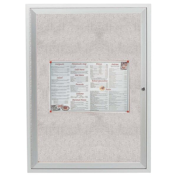 A white menu board with a pin inside a white frame.