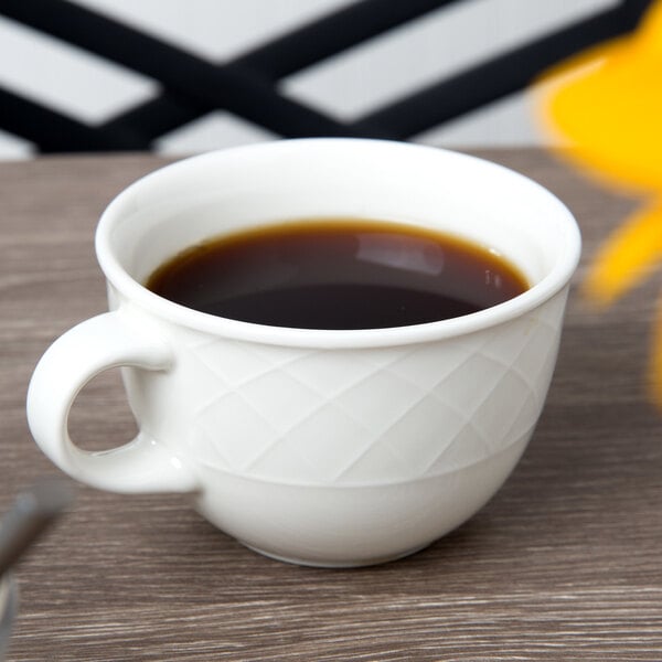 A Villeroy & Boch white porcelain cup of coffee on a table.