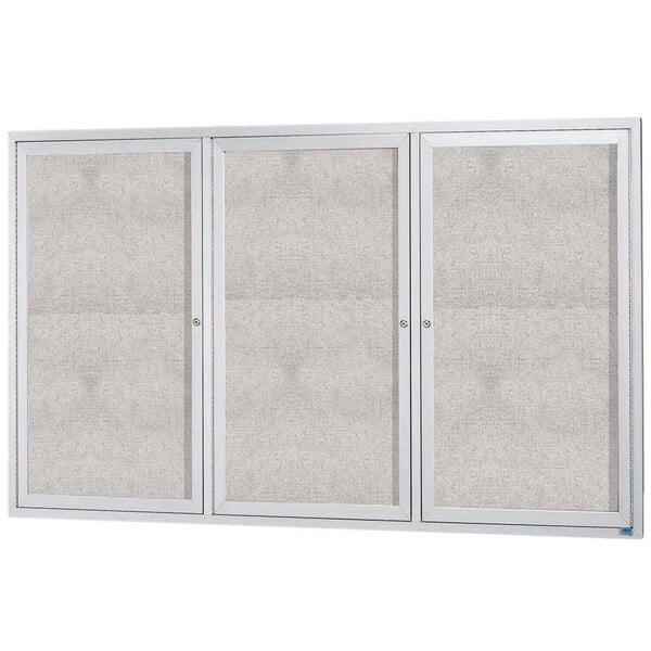 An enclosed white cabinet with three white doors and a white panel.