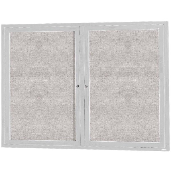 An Aarco white aluminum cabinet with glass doors.