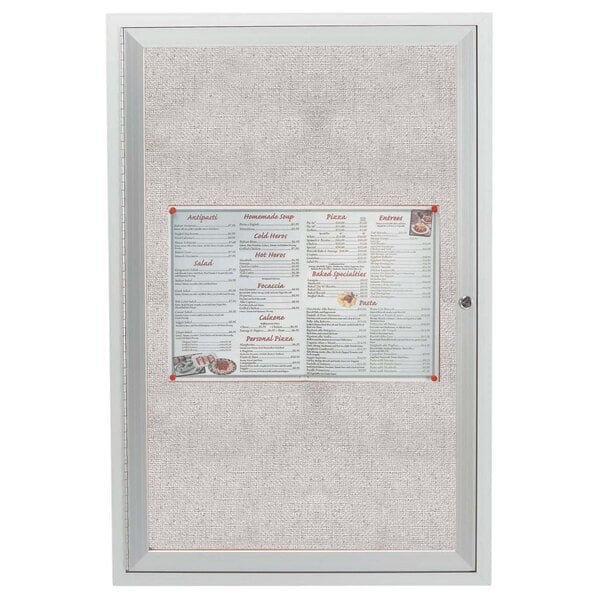 A white Aarco outdoor bulletin board cabinet with a menu inside.