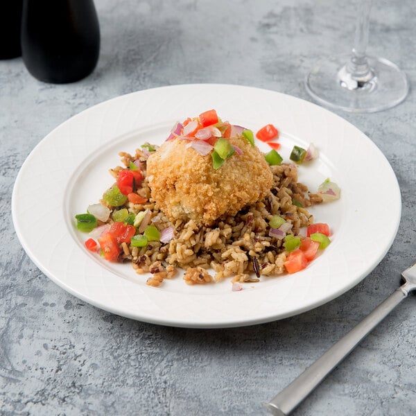 A Villeroy & Boch white porcelain plate with a fried rice and vegetable ball on it.