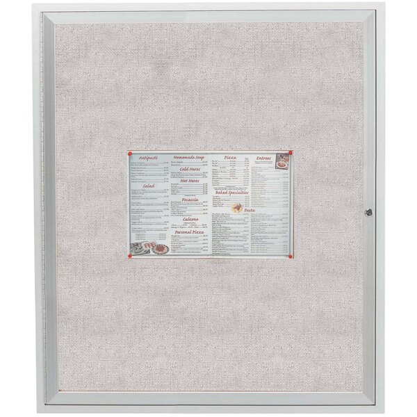 An Aarco satin anodized aluminum enclosed bulletin board with a white menu on it.