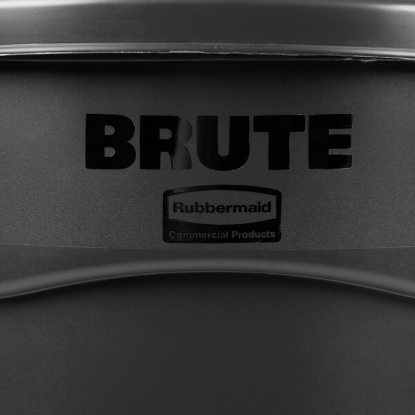 A close up of a black Rubbermaid BRUTE trash can with lid and handle.