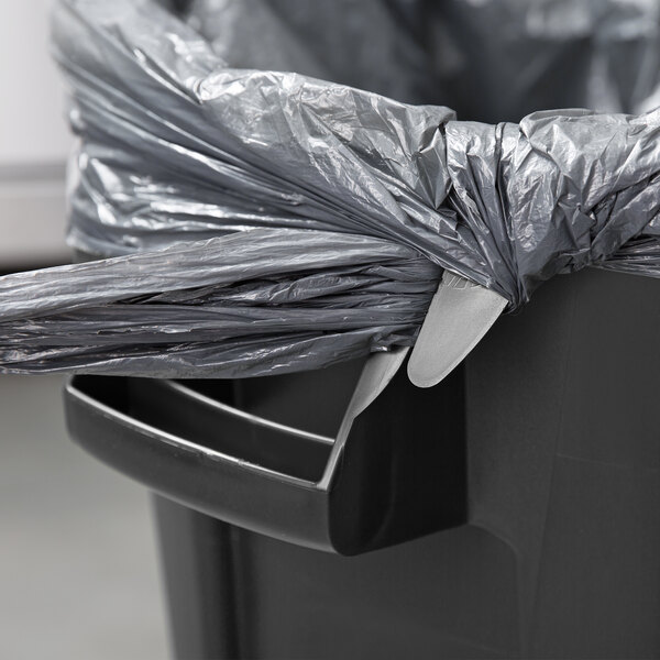 A black Rubbermaid BRUTE round trash can with a lid and a handle.