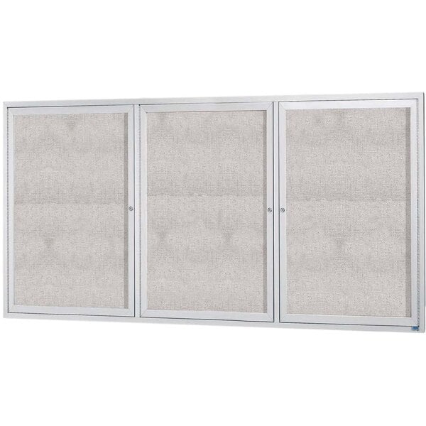 A white rectangular Aarco bulletin board cabinet with glass doors and a white frame.