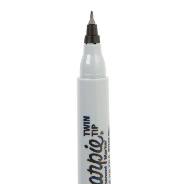 A white Sharpie container with black writing and a black tip.