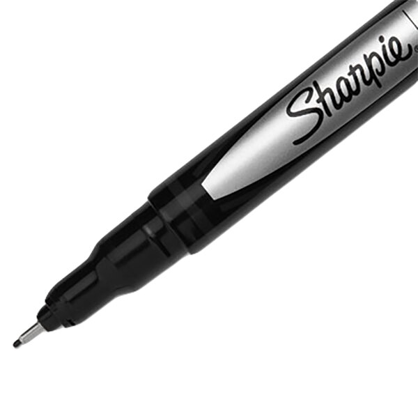 A close up of a Sharpie plastic point stick pen with black ink and a black barrel.