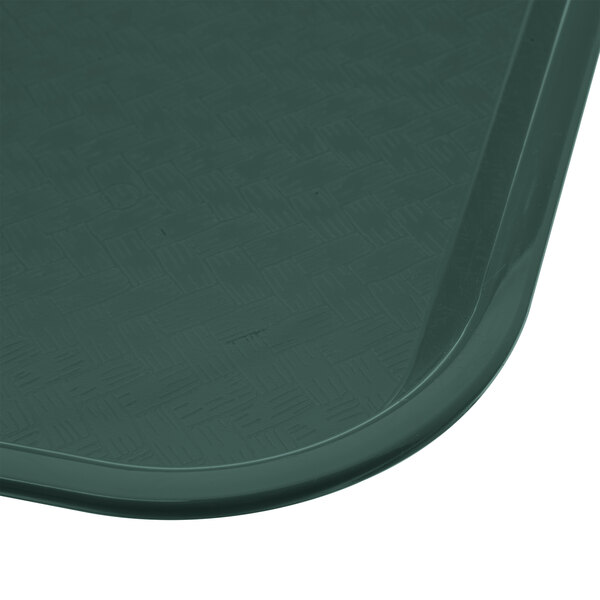 A Carlisle forest green plastic fast food tray with a dark green border.