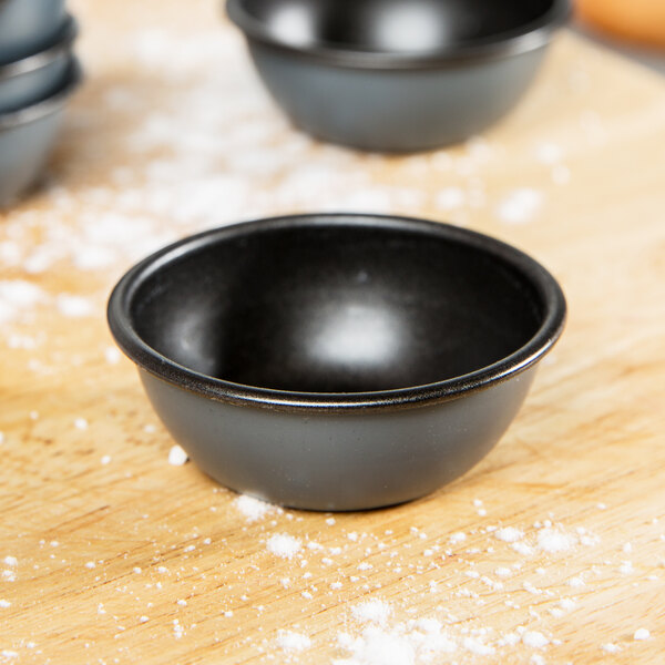 A Matfer Bourgeat Pomponnette mold on a wooden surface.