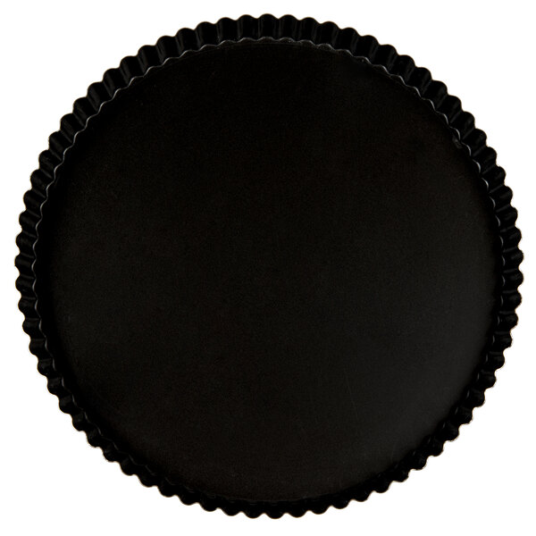 A black round pan with a fluted surface.