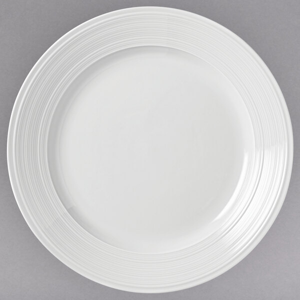A close-up of a white Libbey Galileo Lunar porcelain plate with a spiral pattern on the rim.