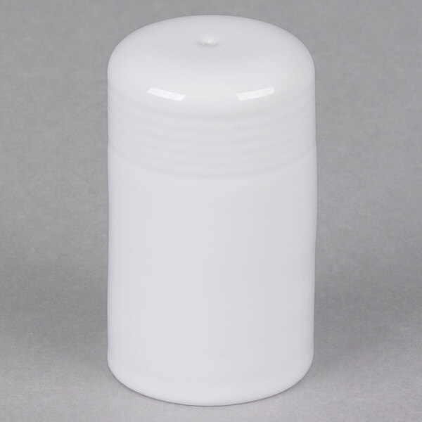 A white china salt shaker with a black lid.