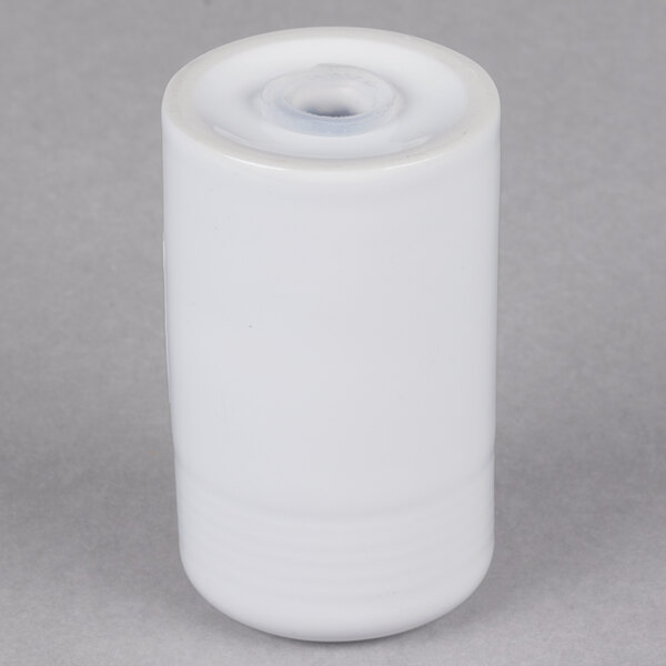 A Tuxton white china cylindrical salt shaker with a lid.