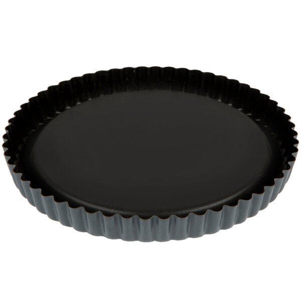 A black Matfer Bourgeat fluted tart pan with a raised bottom.