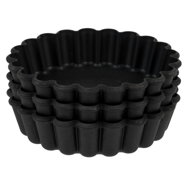 A stack of black fluted tartlet molds.